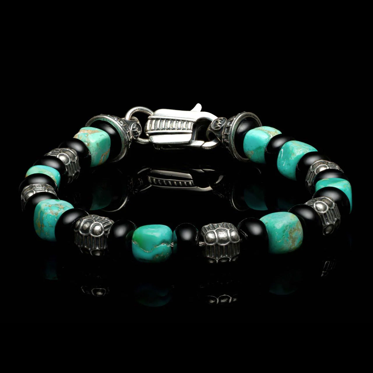 Top view of William Henry Shadowline bracelet showing Kingman turquoise cubes, black onyx beads, sterling silver cubes, on black background