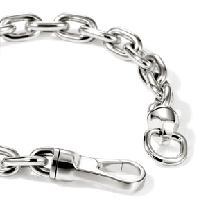 A close-up of a polished silver-tone metal chain with interlocking oval links, a lobster clasp, and a small hanging ring, photographed on a clean white background.