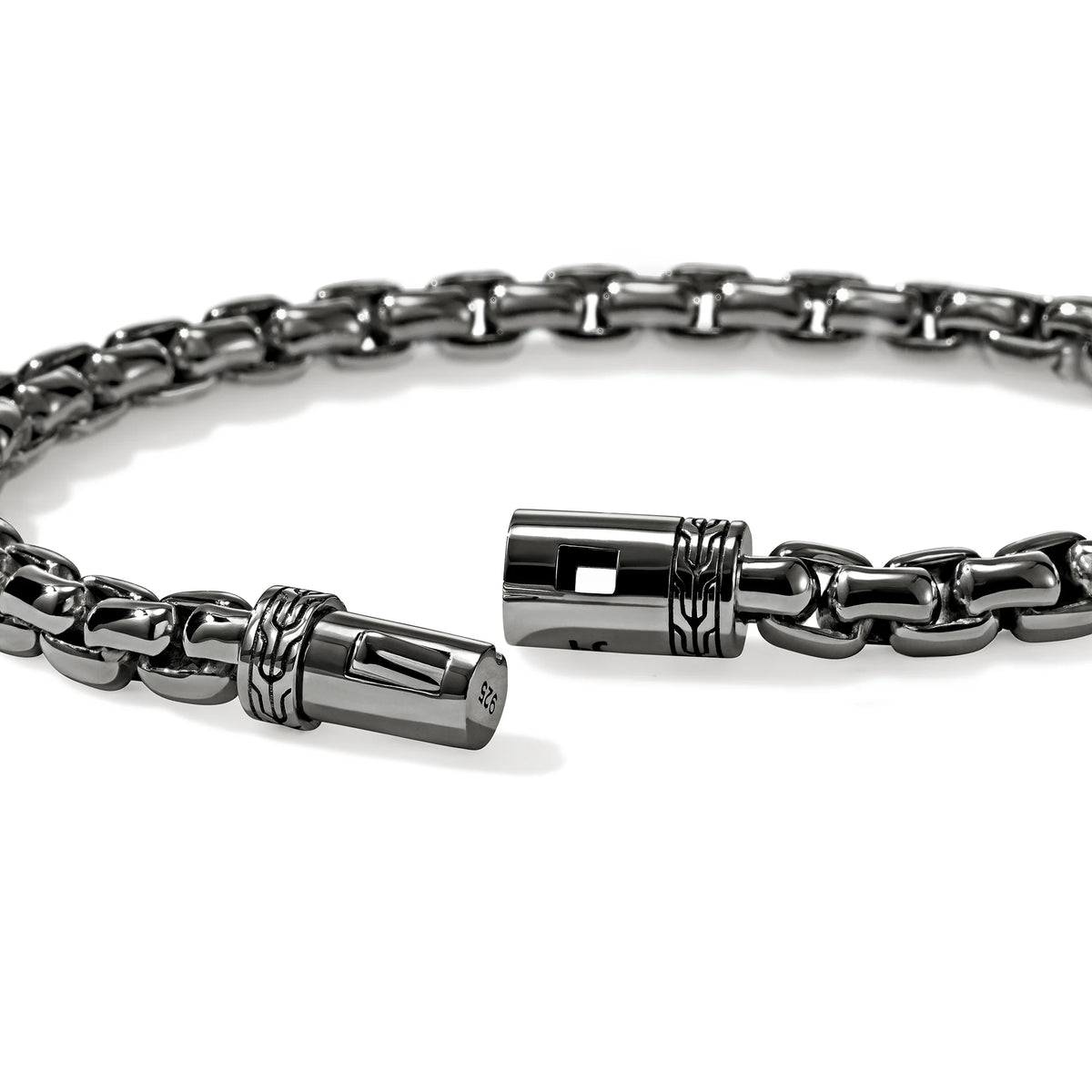 Silver chain bracelet with intricate clasp on a white background