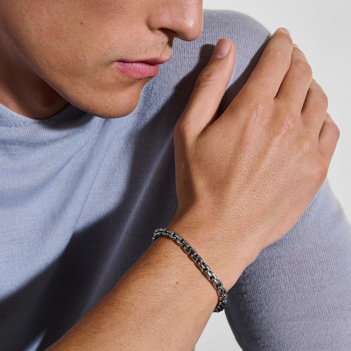 Dark sterling silver box chain bracelet on a white background