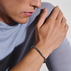 Dark sterling silver box chain bracelet on a white background