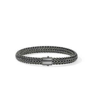 Dark sterling silver bracelet on a white background