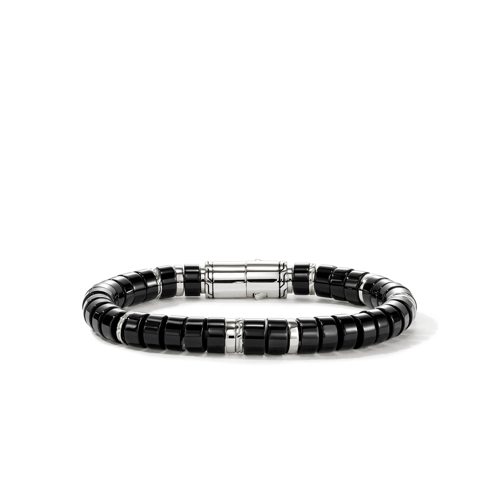 Black beaded bracelet with silver accents on a white background