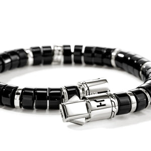 Black beaded bracelet with silver clasp on a white background