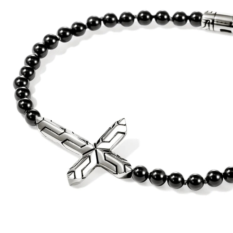 Black beaded bracelet with a silver cross pendant on a white background