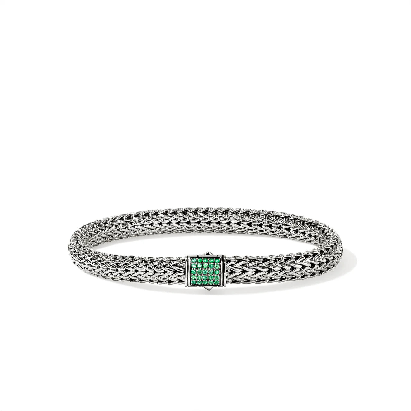 Silver bracelet with emerald gemstones on a white background