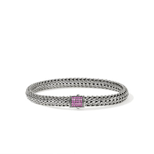 Silver bracelet with a pink sapphires on a white background