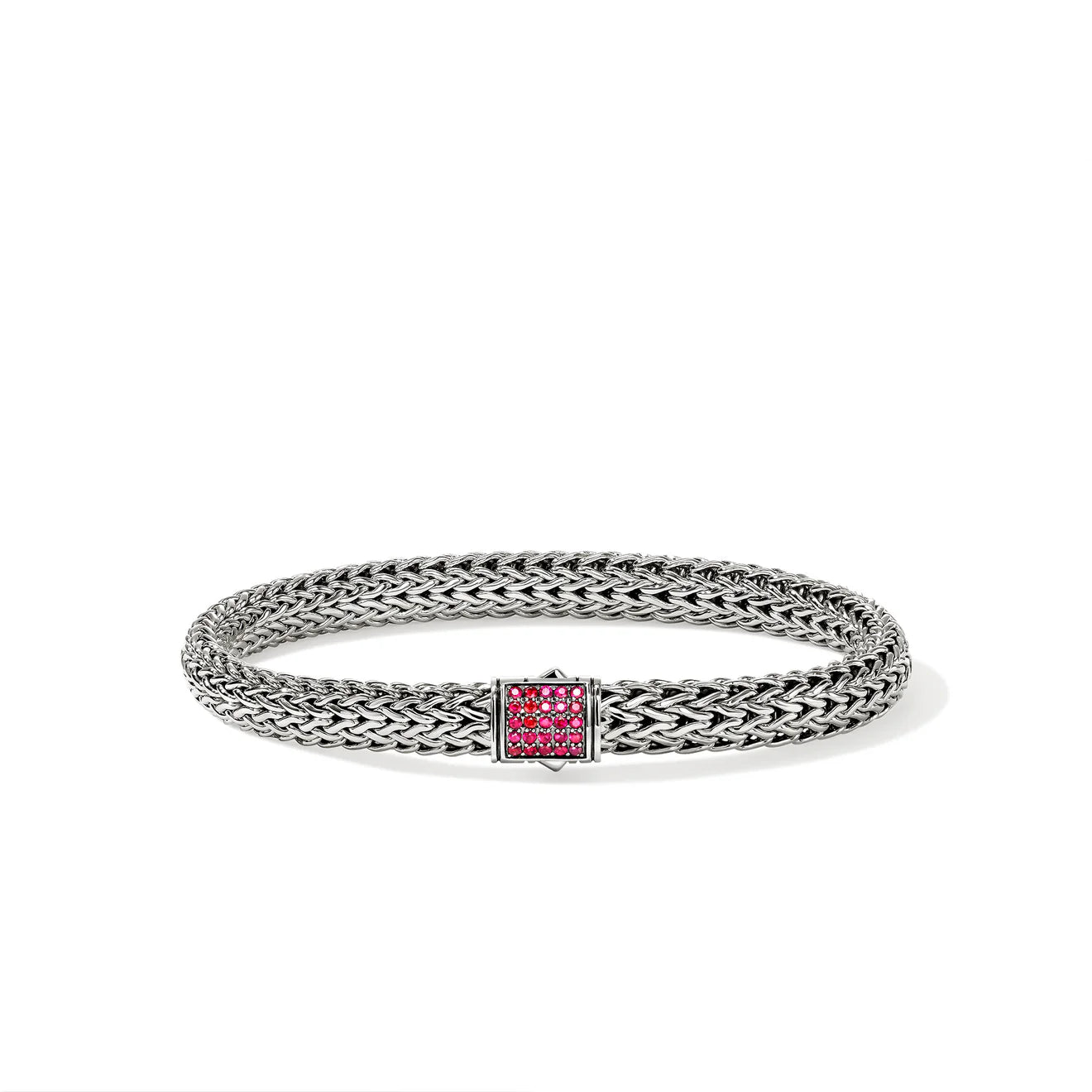 Silver bracelet with a red gemstone on a white background