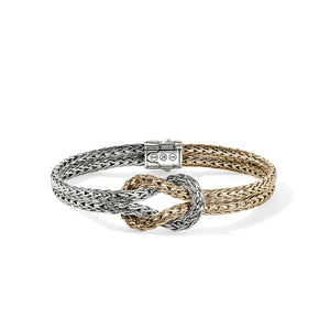 Two braided bracelets, one silver and one gold, on a white background.