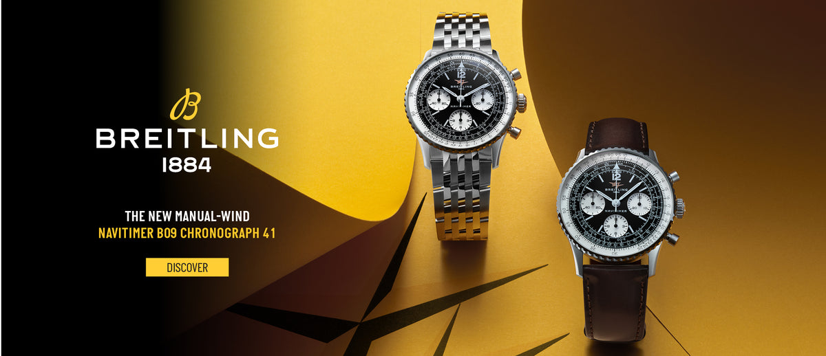 two Breitling watches on a gold background