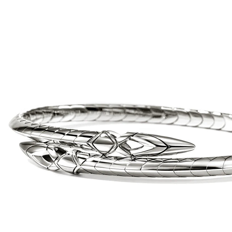 Silver bracelet with intricate design on a white background
