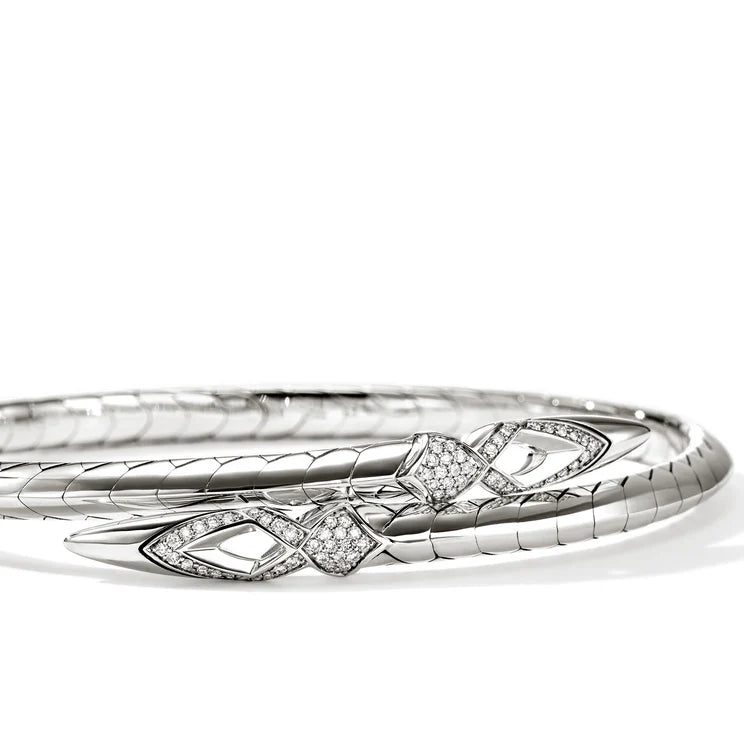 Silver bracelet with diamond accents on a white background