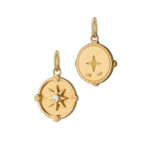 Front and back of mini Adventure compass charm in 18K yellow gold with diamond accented compass rose on white background