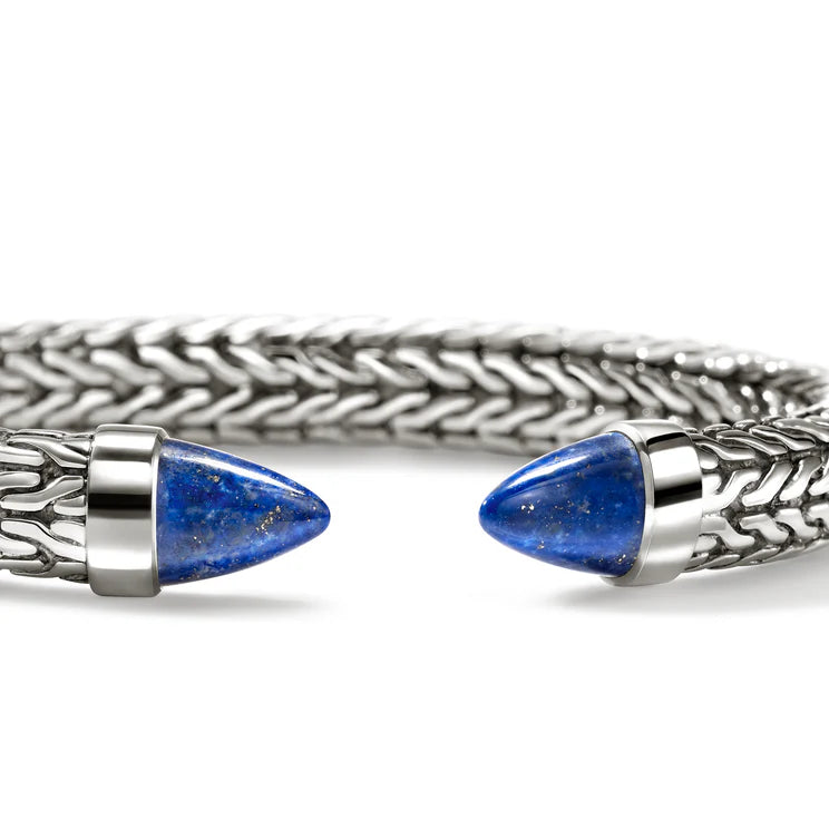 A silver-toned braided cuff bracelet with two pointed blue lapis lazuli stone end caps, shown on a clean white background.