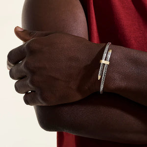 Close-up of a hand wearing a bracelet with a neutral background