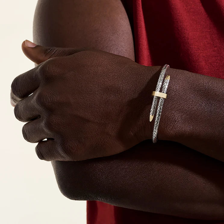 Close-up of a hand wearing a bracelet with a neutral background
