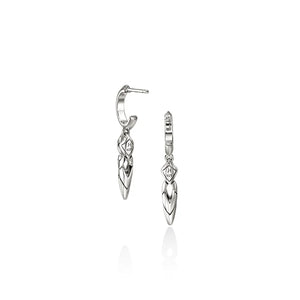 A pair of silver huggie hoop earrings with dangling leaf-shaped charms, shown on a clean white background with a soft reflection below.