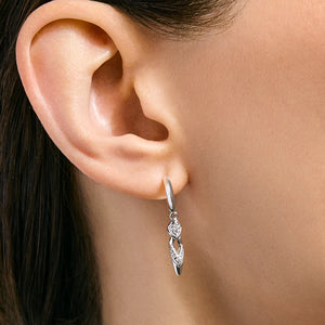 Silver earring worn on a model's ear