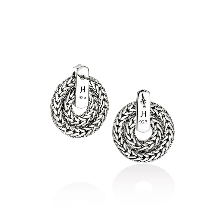 Pair of silver hoop earrings with braided design on a white background