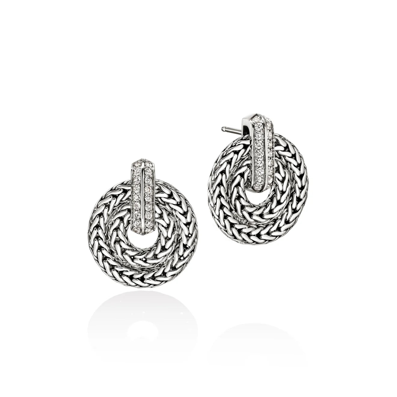 Pair of silver hoop earrings with woven design on a white background