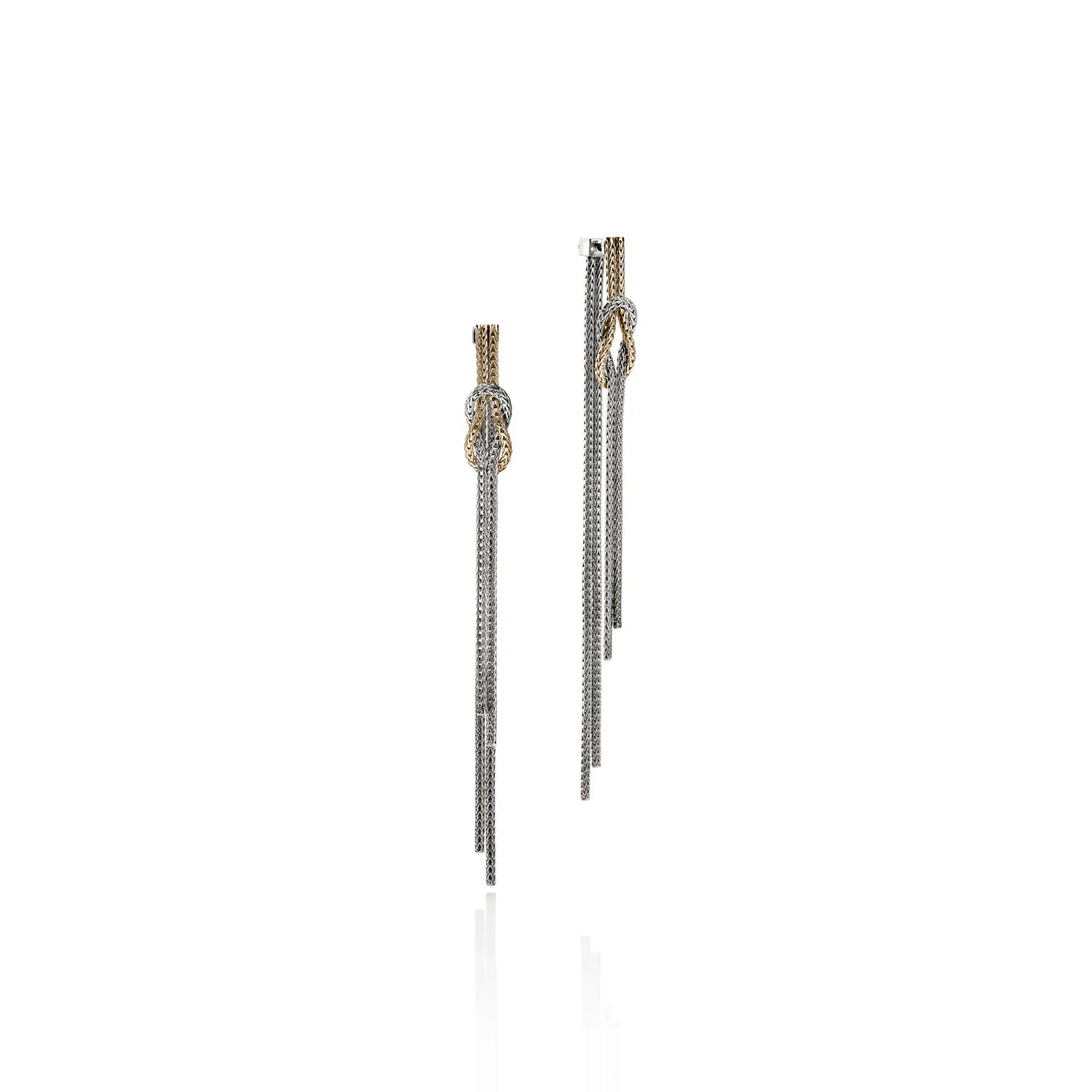 Silver and gold drop earrings tied in a knot  on a white background