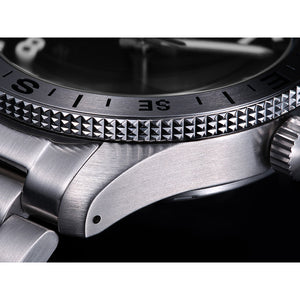 Close-up of a silver watch with detailed bezel and crown.