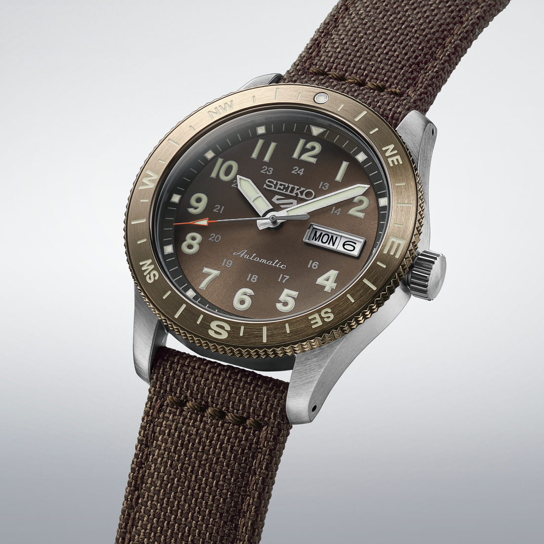 Seiko watch with brown strap and detailed face on a light gray background