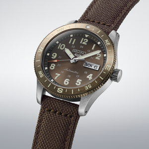 Seiko watch with brown strap and detailed face on a light gray background