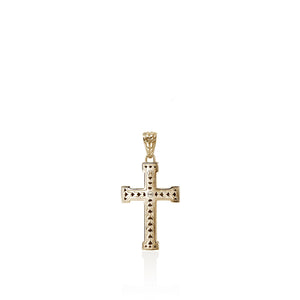 A gold cross pendant with textured, beaded vertical bars and a decorative bail, shown on a clean white background with a soft reflection below.