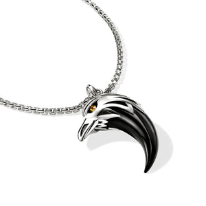 Silver and black eagle head pendant on a chain against a white background