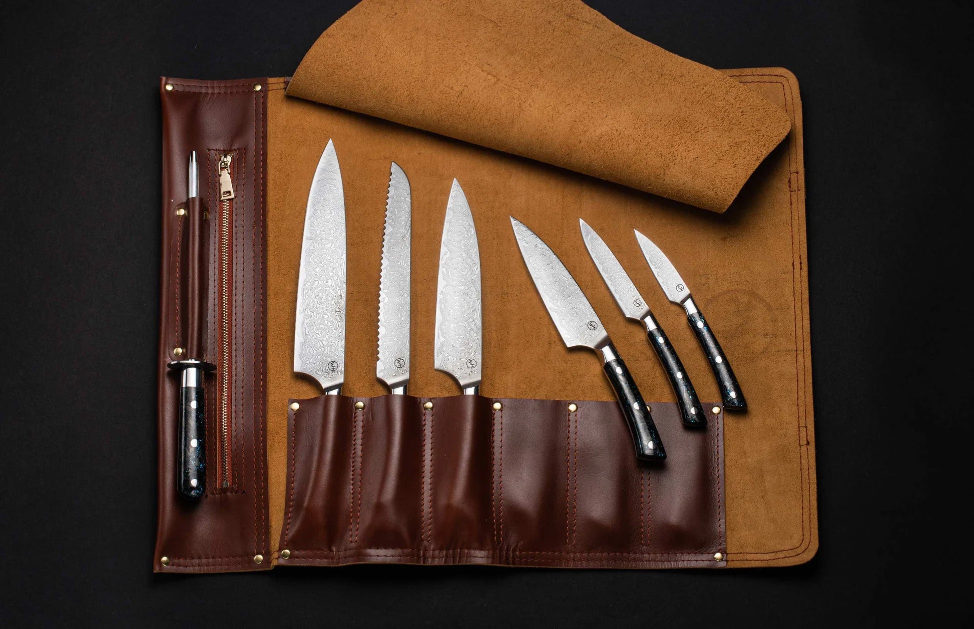 Top-down view of Kultro Pro chef knife set in maple roll, six forged blades with black handles on dark background