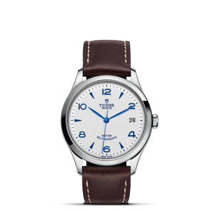 Front view of Tudor 1926 36mm steel watch showing opaline textured white dial with blue numerals and brown leather strap on white background