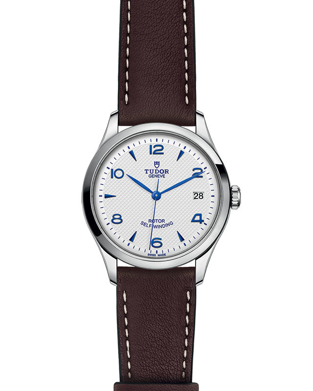 Front view of Tudor 1926 36mm steel watch with opaline dial, blue hands and numerals, brown leather strap, date at 3 o'clock