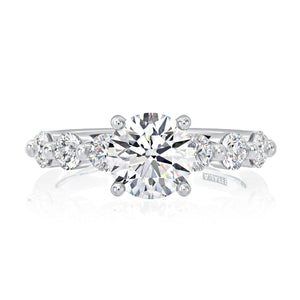 Front view of seven-stone round diamond engagement ring with round center diamond and three diamonds each side on white