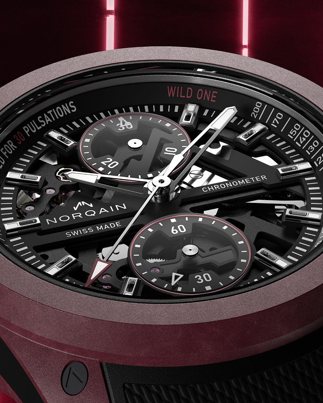 Close-up of a Norqain watch with detailed face and red accents on a dark background