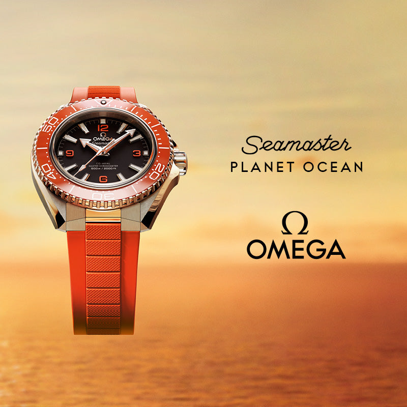 Orange Omega timepiece with a sunset background