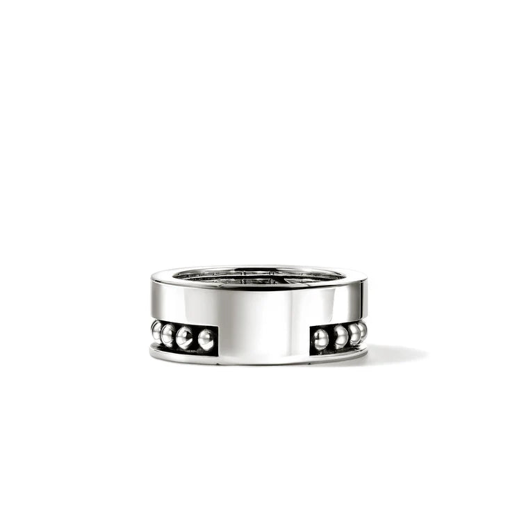 Silver ring with embedded stones on a white background