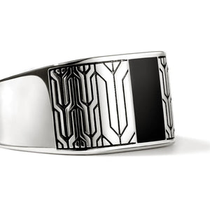 Silver bracelet with black and white pattern on a white background