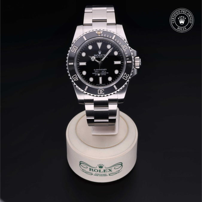 Rolex Submariner stainless steel watch on stand with ROLEX logo and CERTIFIED PRE-OWNED badge