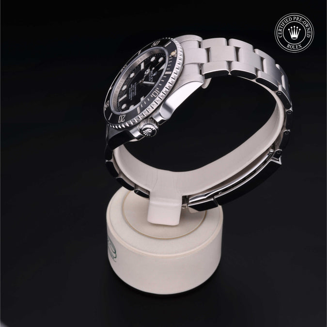 Rolex Submariner on display stand; CERTIFIED PRE-OWNED ROLEX badge visible