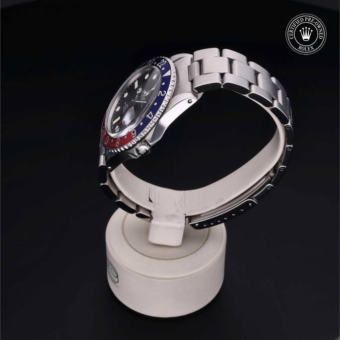 Rolex watch on a display stand with a dark background