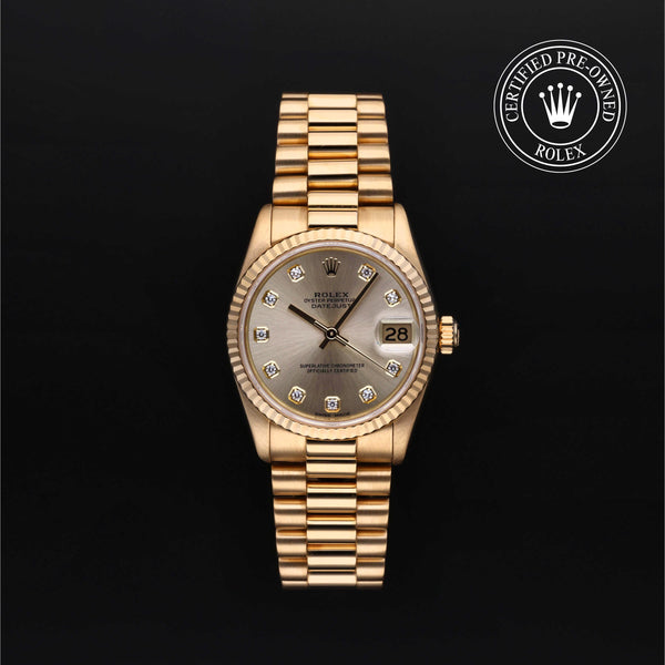 Gold Rolex watch with a champagne face on a black background, featuring the 'Certified Pre-Owned Rolex' logo.