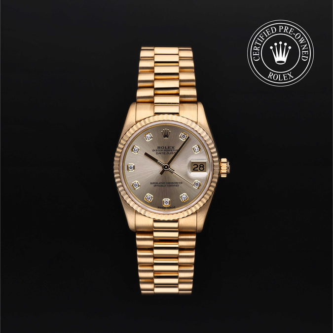 Gold Rolex watch with a champagne face on a black background, featuring the 'Certified Pre-Owned Rolex' logo.