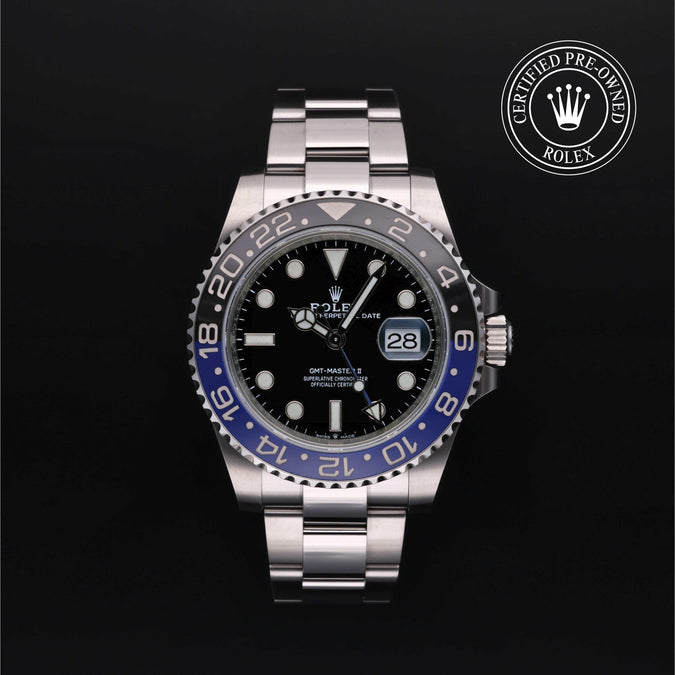 Rolex watch with black dial and blue bezel on a dark background, featuring a 'Certified Pre-Owned Rolex' logo.