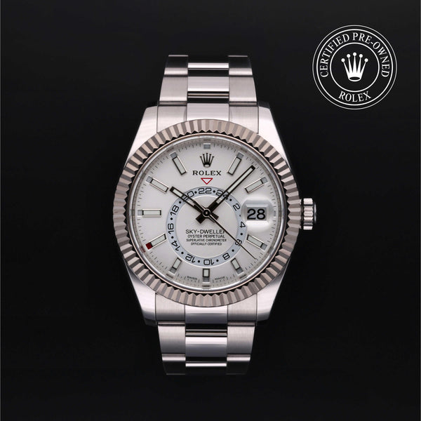 Front of Rolex Sky-Dweller 42mm, fluted bezel, white dial, Oyster bracelet on black background with Certified Pre-Owned seal
