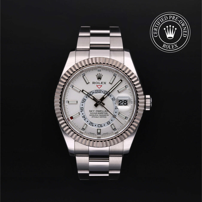 Front of Rolex Sky-Dweller 42mm, fluted bezel, white dial, Oyster bracelet on black background with Certified Pre-Owned seal