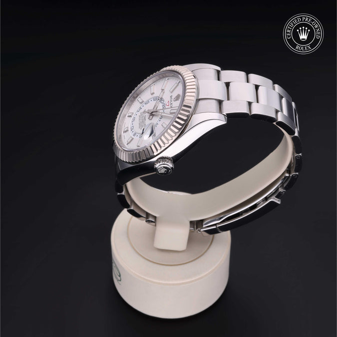 Silver watch on a display stand with a dark background