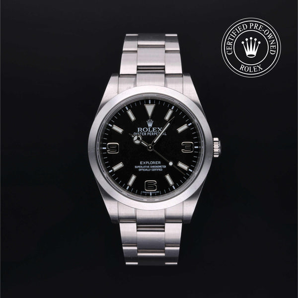 Rolex watch with black dial on a dark background, featuring the Rolex logo.