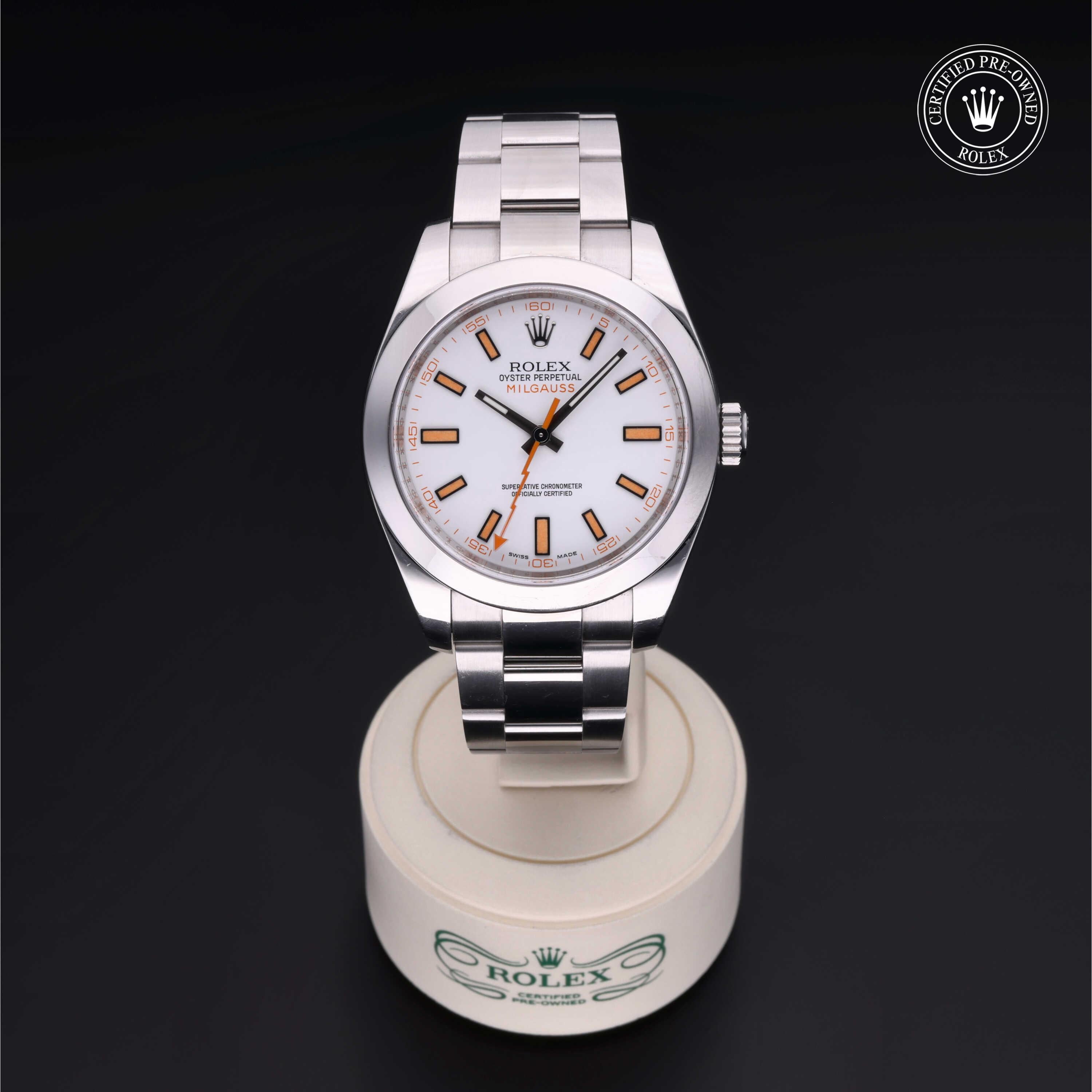 Silver Rolex watch on a white stand with a black background