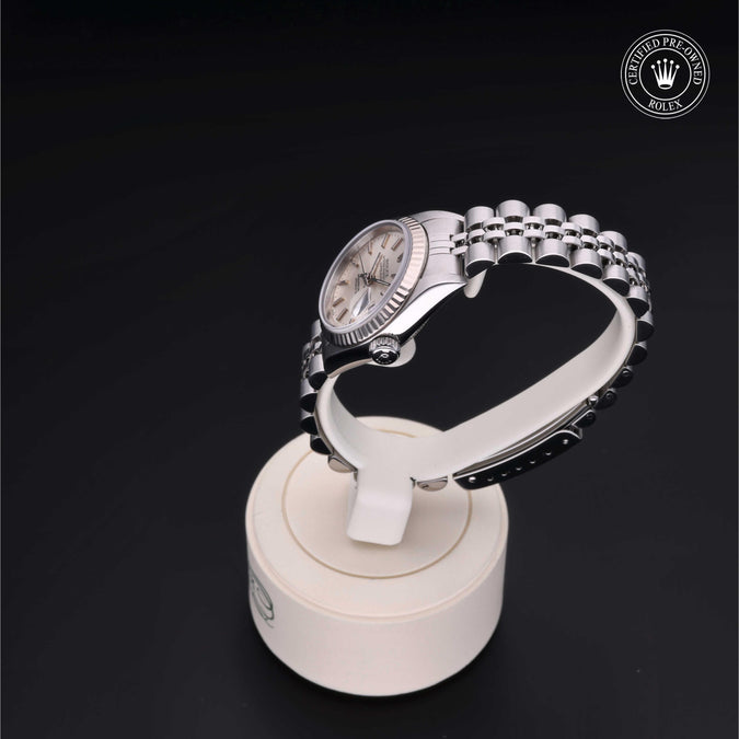 Silver watch on a black background with a visible brand logo.